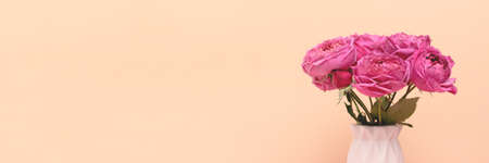 Banner with bouquet of pink rose flowers in vase in front of beige background. Gift for 8 March, Mothers Day with copyspace.の写真素材