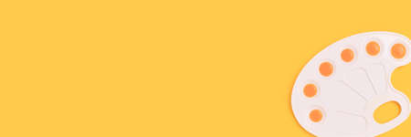 Banner with watercolor palette on a yellow background. Artistic concept with place for text.