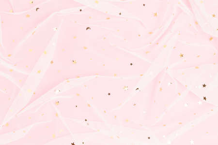 Minimal pink pastel colored background with shiny golden glitter.の写真素材