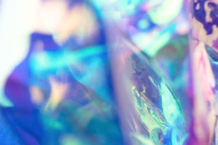 Blurred holographic colorful background. Defocused texture in blue colors.の写真素材