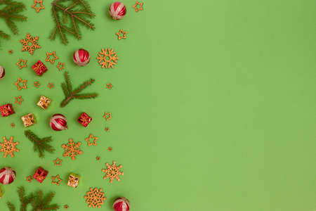 Christmas decorations pattern on a green background. Holidays composition with place for text.