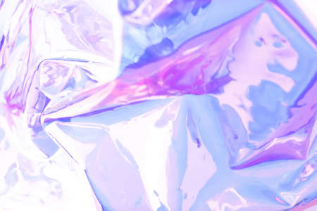 Blurred holographic background. Defocused multicolored texture of wrinkled foil in purple colors.の写真素材