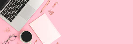 Banner with coffee, office supply and laptop on a pink background. Distance work, e-learning concept with copy space.の写真素材