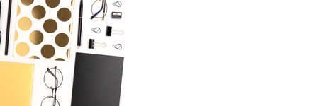 Layout of black and gold colored office stationery on a white background. Neat workspace with place for text.の写真素材