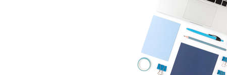 Banner with laptop and blue office supplies on a white background. Neat workspace for e-learning.の写真素材