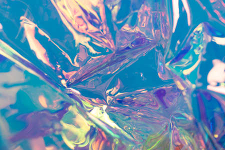 Blue defocused holographic backdrop. Wrinkled foil material. Fluid futuristic texture.の写真素材