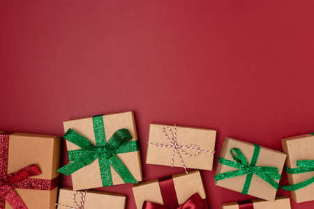 Wrapped gifts on a red background. New Year composition. Boxing day concept.