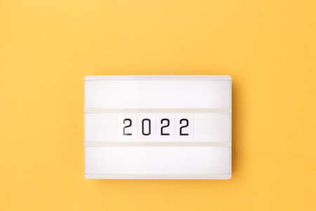 White lightbox with 2022 numbers on a golden background with copy space.の写真素材