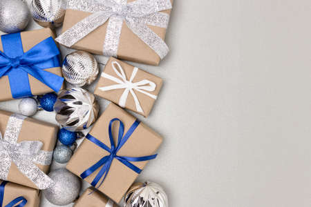 Christmas decorations and gifts on a silver background with palce for text.の写真素材