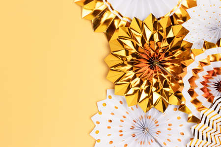 Gold colored paper fans with place for text. Monochrome concept.の写真素材