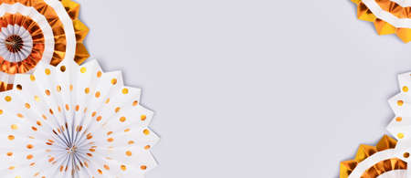 Banner with frame made of gold colored paper fans on a blue background with copy space.の写真素材