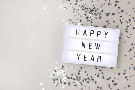 Happy New Year. Lightbox and stars confetti on a silver background with place for text.の写真素材