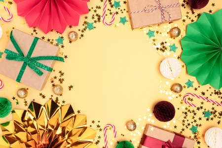 Festive composition with gifts and Christmas decorations on a gold colored background.の写真素材