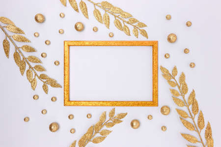 Empty frame made from gold colored glittering decorations on a blue background.の写真素材