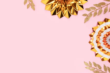 Golden paper fans and glittering branches on a pink background. Festive concept with place for text.の写真素材