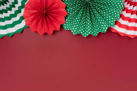 Frame made of paper fans on a red background. Festive concept with copy space.の写真素材