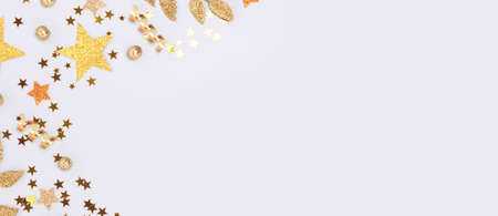 Banner with gold colored glittering decorations on a blue background.