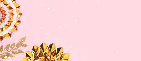 Banner with golden paper fans and glittering branches on a pink background. Festive concept with...