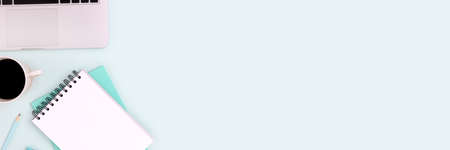 Banner with laptop, coffee and stationery on a blue background. E-learning, online study concept with place for text.の写真素材