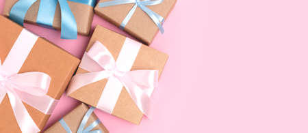 Banner with group of gift boxes on a pink pastel background. Present tied ribbon.の写真素材