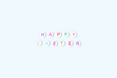 Happy Easter. Quote made of white round beads with colorful letters on a blue background.の写真素材