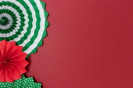 Border frame made of paper fans. Red and green decorations with copy space.の写真素材