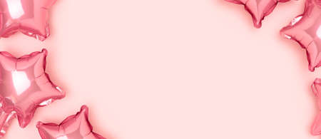 Banner with frame made of pink pastel star balloons. Baby shower concept with copyspace.
