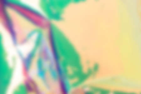 Blurred holographic background. Defocused multicolored texture of wrinkled foil.の写真素材