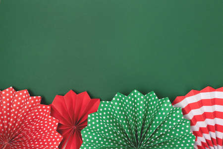 Frame made of paper fans on a green background. Festive concept with place for text.の写真素材