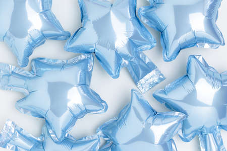 Texture made of blue star foil balloons. Creative background in pastel colors.