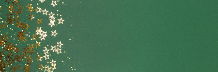 Banner with metallic gold colored stars confetti on a green background with place for text.