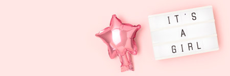 Its a girl - quote. Banner with pink star foil balloon and lightbox. Place for text.の写真素材