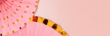 Banner with paper fans on a pink glittering background. Holiday decorations with place for text.の写真素材