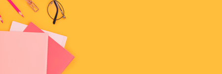 Banner with pink colored school supplies on a yellow background.の写真素材
