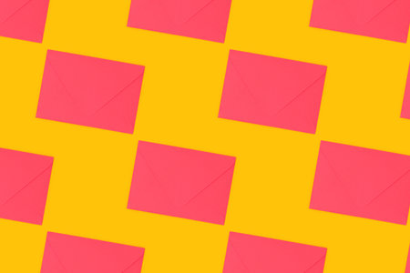 Repetitive pattern made of pink envelopes on a pink background.の写真素材