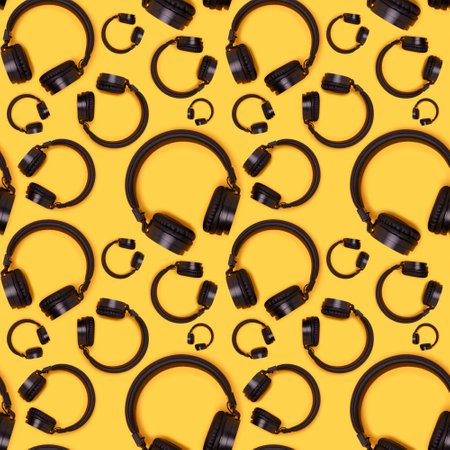 Seamless pattern made of black wireless headphones on a yellow background. creative concept.