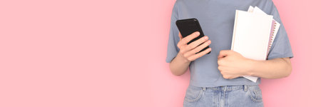 Banner with woman holding books in her hands and use smartphone. Education concept.の写真素材