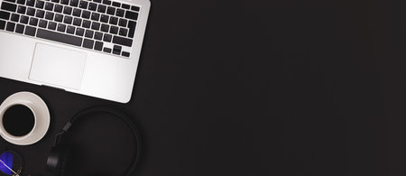 Banner with eyeglasses, laptop, cup of coffee and headphones on a black background. Business concept...