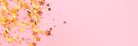 Banner with glowing golden ribbons, stars and crystals confetti on a pink background. selective focus.の写真素材