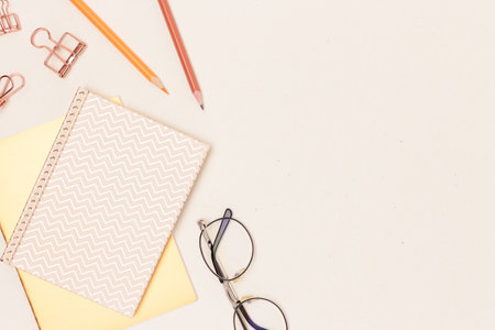 School supplies and eyeglasses on a beige background. Business concept with copy space.の写真素材