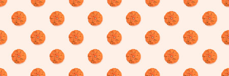 Banner with pattern made of orange pumpkin on a beige background.の写真素材