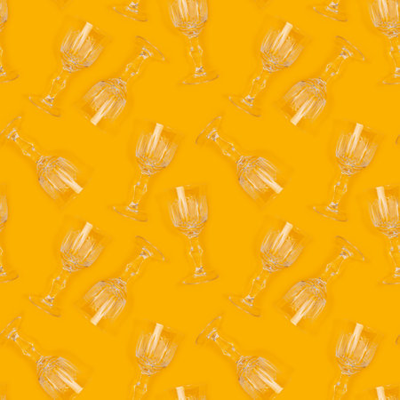 Seamless pattern made of vintage crystal glasses on a yellow background. creative concept.の写真素材