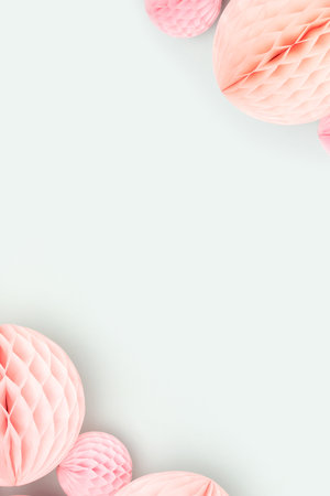 Frame made of pink tissue paper balls on a blue background. Creative concept.の写真素材