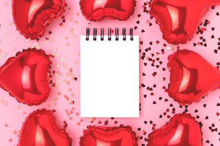 Frame made of inflatable foil balloons in a heart shape. Empty notepad mockup on a pink background.の写真素材