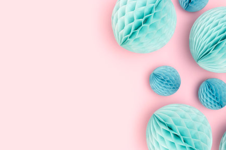Blue tissue paper balls different sizes scattered on a pink background. Place for your design.の写真素材