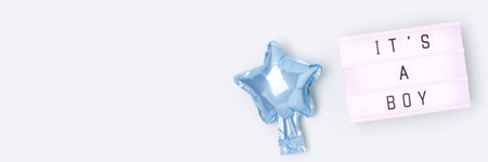 Its a boy - quote. Banner with blue star foil balloon and lightbox. Place for text.の写真素材