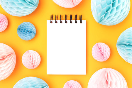 Empty notepad mockup and tissue paper balls in a blue and pink colors on a yellow background.の写真素材