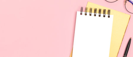 Banner with blank notepad mockup and stationery on a pink background. office supplies.の写真素材
