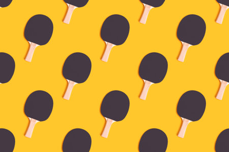 Repetitive pattern made of tennis racket on a yellow background.の写真素材