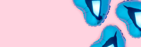 Banner with blue inflatable balloons in a heart shape on a pink background. Festive concept.の写真素材